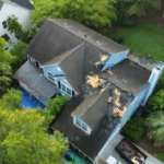 Roofing professional inspecting hurricane roof damage on a Lowcountry home